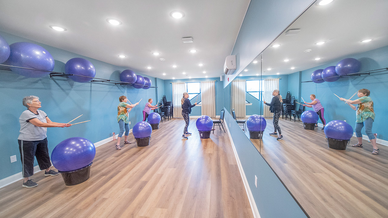 people using exercise balls in gym